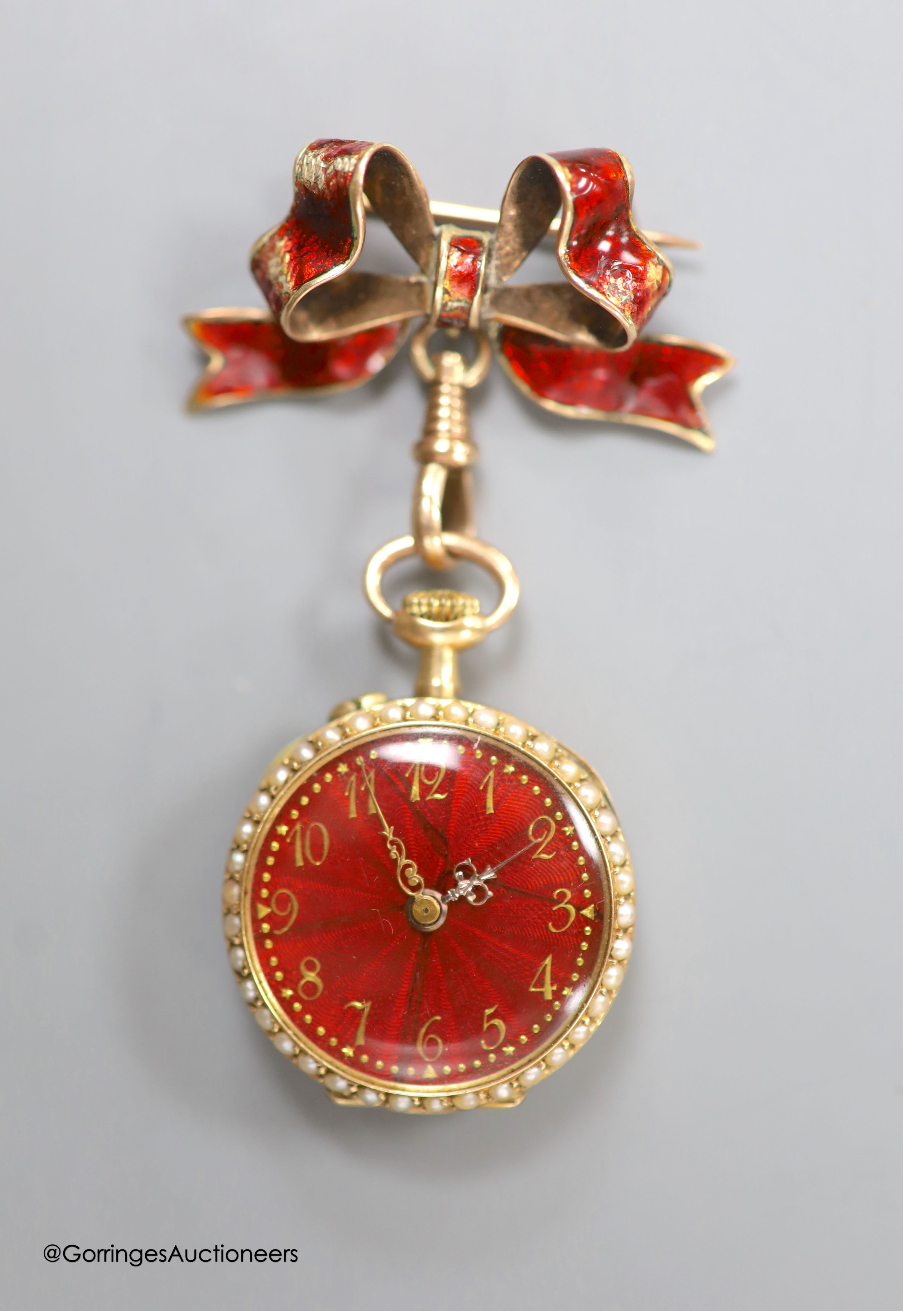 A lady's early 20th century 14k yellow metal, red enamel and seed pearl set fob watch(a.f.), case diameter 26mm, gross 15.5 grams, on a 9ct and red enamel bow brooch, gross 4.6 grams.